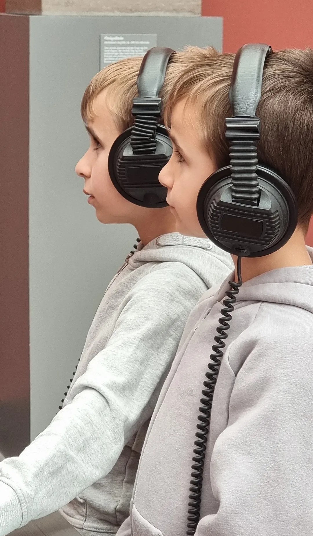 Children wearing headphones in the museum