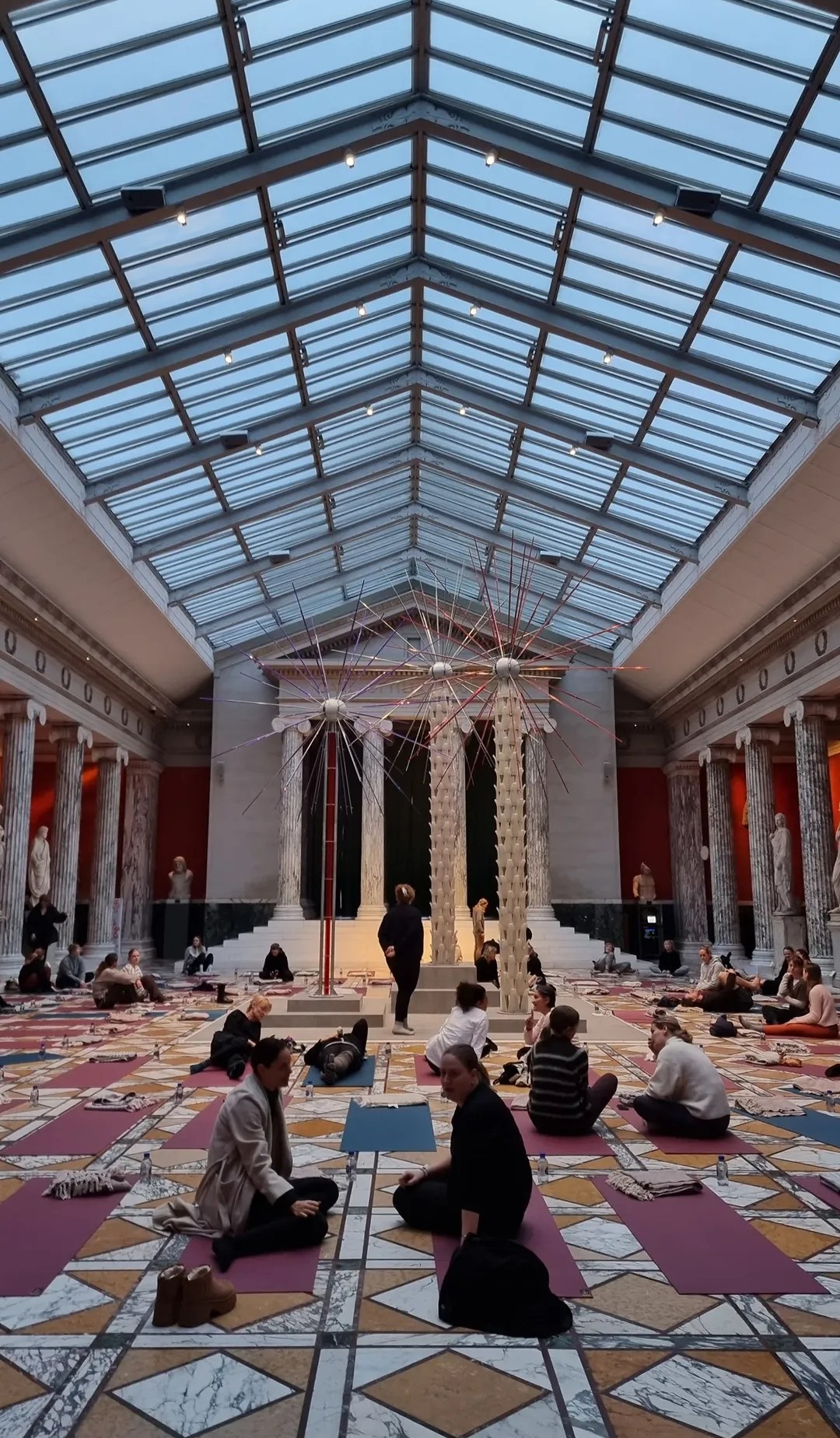 Yoga mats beneath the Glyptotek glass roof